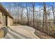 A backyard featuring a concrete patio, brick home, chain link fence and trees at 7023 Mustang Ct, Martinsville, IN 46151
