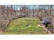 Expansive fenced backyard with a picnic table, shed, and mature trees at 7023 Mustang Ct, Martinsville, IN 46151
