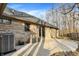 The backyard shows a brick home with a patio, fenced yard, and exterior AC unit at 7023 Mustang Ct, Martinsville, IN 46151