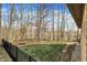 Fenced backyard featuring green grass and mature trees at 7023 Mustang Ct, Martinsville, IN 46151