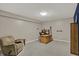 Finished basement with carpet, overhead lighting, cozy chair, and functional desk area perfect for office space at 7023 Mustang Ct, Martinsville, IN 46151