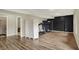 Basement features wood flooring, black accent wall, and recreational equipment, creating versatile living area at 7023 Mustang Ct, Martinsville, IN 46151