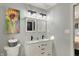 Stylish bathroom with a double vanity, framed mirrors, modern lighting, and a gray walls for a serene atmosphere at 7023 Mustang Ct, Martinsville, IN 46151