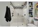 Modern bathroom featuring a shower-tub, decorative tile, and built-in storage shelves for an organized and stylish space at 7023 Mustang Ct, Martinsville, IN 46151
