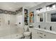 Bright bathroom with a tiled shower and tub combination, double vanity with framed mirrors, and modern fixtures at 7023 Mustang Ct, Martinsville, IN 46151