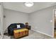 A gray bedroom features a loveseat, wooden chest, and unique decor at 7023 Mustang Ct, Martinsville, IN 46151