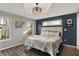 Primary bedroom with hardwood floors, tray ceiling, and ample natural light at 7023 Mustang Ct, Martinsville, IN 46151