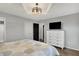 A charming bedroom with a decorative ceiling fixture and a modern white dresser with a flat screen television at 7023 Mustang Ct, Martinsville, IN 46151