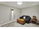 Cozy bedroom features a loveseat, wooden chest, and window dressed with soft curtains at 7023 Mustang Ct, Martinsville, IN 46151