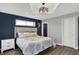 Primary bedroom with hardwood floors, tray ceiling, and black out shades at 7023 Mustang Ct, Martinsville, IN 46151
