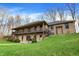 Two-story brick home with a covered porch, walk out basement, and well-maintained lawn at 7023 Mustang Ct, Martinsville, IN 46151