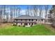 Two-story brick home featuring an upper level deck, lower level patio, and expansive green lawn at 7023 Mustang Ct, Martinsville, IN 46151