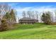 Two-story home set on a spacious green lawn with mature trees at 7023 Mustang Ct, Martinsville, IN 46151