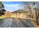 Two-car garage with asphalt driveway and basketball hoop at 7023 Mustang Ct, Martinsville, IN 46151