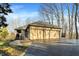 Home featuring a two-car garage, brick facade, and manicured lawn at 7023 Mustang Ct, Martinsville, IN 46151