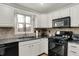 Kitchen features granite countertops, stainless appliances, and modern backsplash at 7023 Mustang Ct, Martinsville, IN 46151