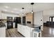 Open kitchen with stainless appliances, a center island, and brick fireplace at 7023 Mustang Ct, Martinsville, IN 46151