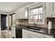 Kitchen sink with granite countertops, stainless dishwasher, and a view to the deck at 7023 Mustang Ct, Martinsville, IN 46151