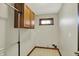 Laundry room with overhead cabinets, window, and neutral flooring at 7023 Mustang Ct, Martinsville, IN 46151