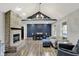 Bright living room featuring a brick fireplace, vaulted ceilings, and stylish gray walls at 7023 Mustang Ct, Martinsville, IN 46151