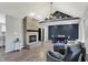 Spacious living room featuring a brick fireplace, vaulted ceilings, and modern gray furniture at 7023 Mustang Ct, Martinsville, IN 46151