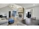 Open-concept living area featuring a brick fireplace, vaulted ceilings, and modern furnishings at 7023 Mustang Ct, Martinsville, IN 46151