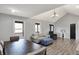 Bright living room featuring vaulted ceilings, modern decor, and natural light from large windows at 7023 Mustang Ct, Martinsville, IN 46151