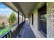 Long porch with wood floors overlooking private yard at 7023 Mustang Ct, Martinsville, IN 46151