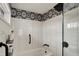 Close up of a bathtub-shower combination with white subway tile, a matte black shower head, and grab bar at 7023 Mustang Ct, Martinsville, IN 46151