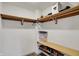Organized walk-in closet with light wood shelving and laminate floors offers lots of storage space at 7023 Mustang Ct, Martinsville, IN 46151