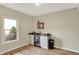 Wet bar area in the basement features cabinetry, a small beverage fridge, and a window for natural light at 7023 Mustang Ct, Martinsville, IN 46151