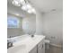 Well-lit bathroom with a double vanity, a large mirror, and a view of the bathtub area at 733 Keepsake Run, Greenwood, IN 46143