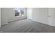 Neutral-toned bedroom featuring plush carpeting, white walls, and ample natural light from the window at 733 Keepsake Run, Greenwood, IN 46143