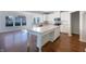 Modern kitchen featuring white cabinets, stainless steel appliances, hardwood floors, and a center island at 733 Keepsake Run, Greenwood, IN 46143