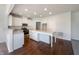 Modern kitchen featuring stainless appliances, marble countertops, hardwood floors and a large island at 733 Keepsake Run, Greenwood, IN 46143