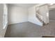 Bright living room featuring neutral walls, carpet and a white staircase at 733 Keepsake Run, Greenwood, IN 46143
