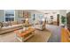 Inviting living room with a neutral palette, stylish furnishings, and abundant natural light, seamlessly connected to the kitchen at 733 Keepsake Run, Greenwood, IN 46143
