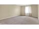 Well-lit bedroom with neutral carpet and a window, offering a calm ambiance at 7607 Farm View E Cir, Indianapolis, IN 46256