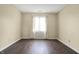 Bedroom with neutral walls, gray flooring, and a bright window at 7607 Farm View E Cir, Indianapolis, IN 46256
