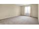 Bright bedroom with neutral carpet and a window; ready for personalization and comfort at 7607 Farm View E Cir, Indianapolis, IN 46256