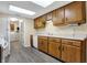 Kitchen with wood cabinets, white appliances, gray flooring, and a skylight at 7607 Farm View E Cir, Indianapolis, IN 46256