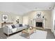 Bright living room boasts a fireplace, neutral paint, and a cozy seating area with stylish decor at 7607 Farm View E Cir, Indianapolis, IN 46256