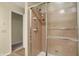 Bathroom shower with sliding glass door featuring tiled walls and showerhead at 7607 Farm View E Cir, Indianapolis, IN 46256