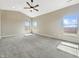 A light filled primary bedroom with high ceilings and neutral carpet at 943 Foxglove St, Lebanon, IN 46052