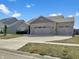 Single-story home featuring stone accents, three-car garage, and attractive landscaping at 943 Foxglove St, Lebanon, IN 46052