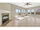 Bright living area with a fireplace, tile flooring, and a sliding glass door that leads to the backyard deck at 943 Foxglove St, Lebanon, IN 46052