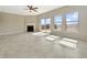 Spacious living room features a fireplace, sliding door access to a deck, and large windows at 943 Foxglove St, Lebanon, IN 46052