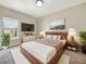 Relaxing main bedroom with large bed, mounted television, and view of neighborhood at 943 Foxglove St, Lebanon, IN 46052