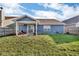 Spacious backyard features a covered patio with a swing and a well-maintained lawn at 972 Redwood Dr, Franklin, IN 46131