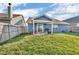 Backyard with a covered patio, fencing, and green lawn, perfect for outdoor enjoyment at 972 Redwood Dr, Franklin, IN 46131